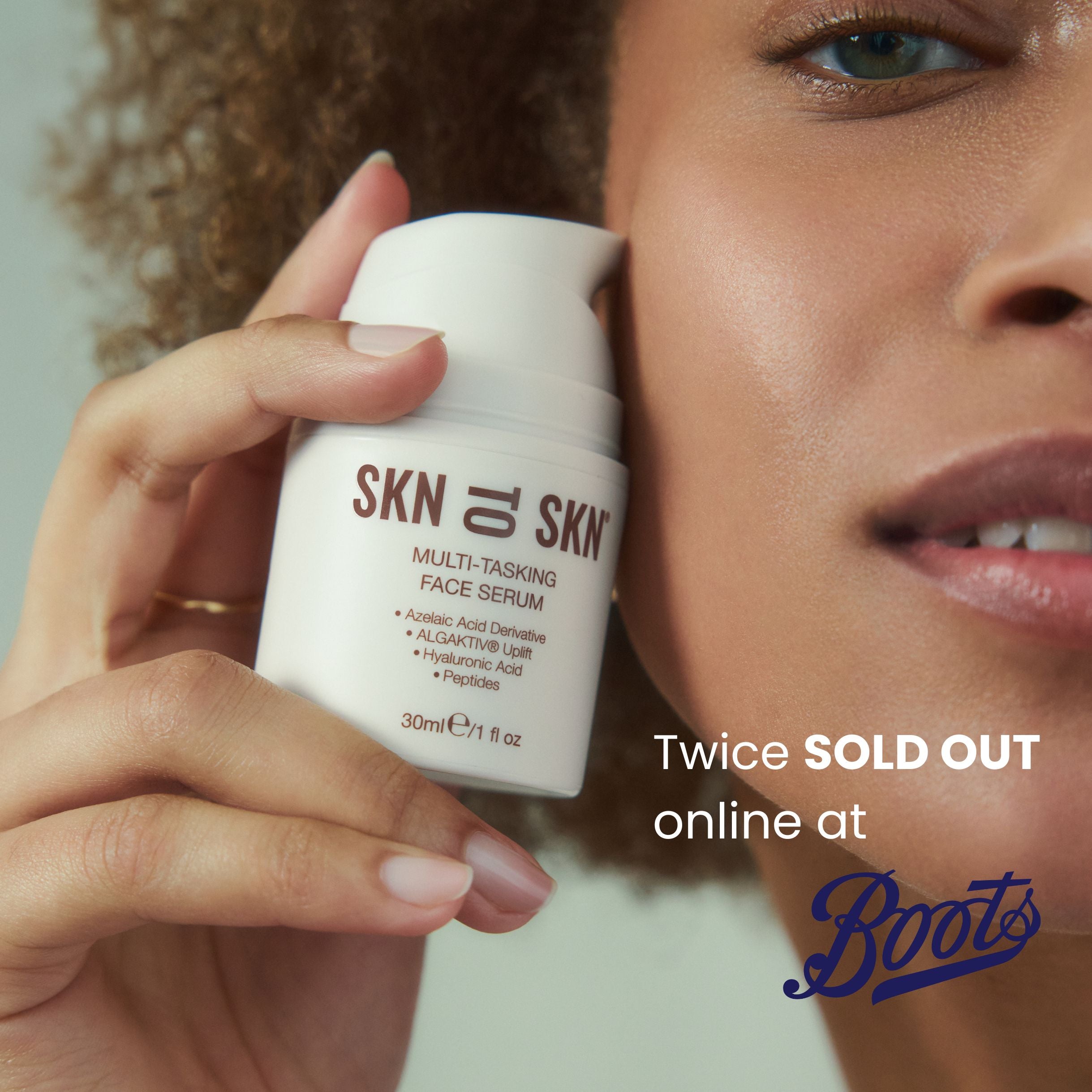 woman holding serum bottle